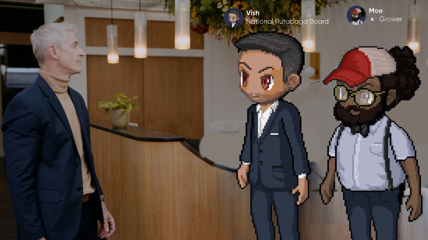 An office lobby with two digital avatars and one person